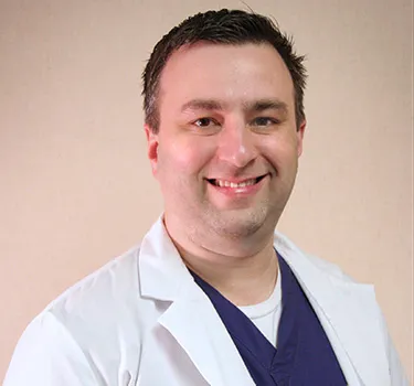 Dr. James Hargrove smiling wearing a white dental lab coat