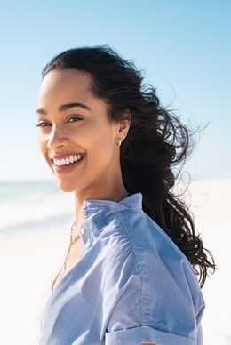 Smiling female patient with blue shirt and white teeth